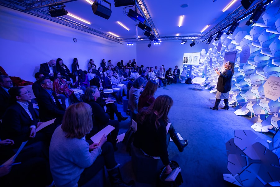 Woman speaking on a conference stage in front of an audience