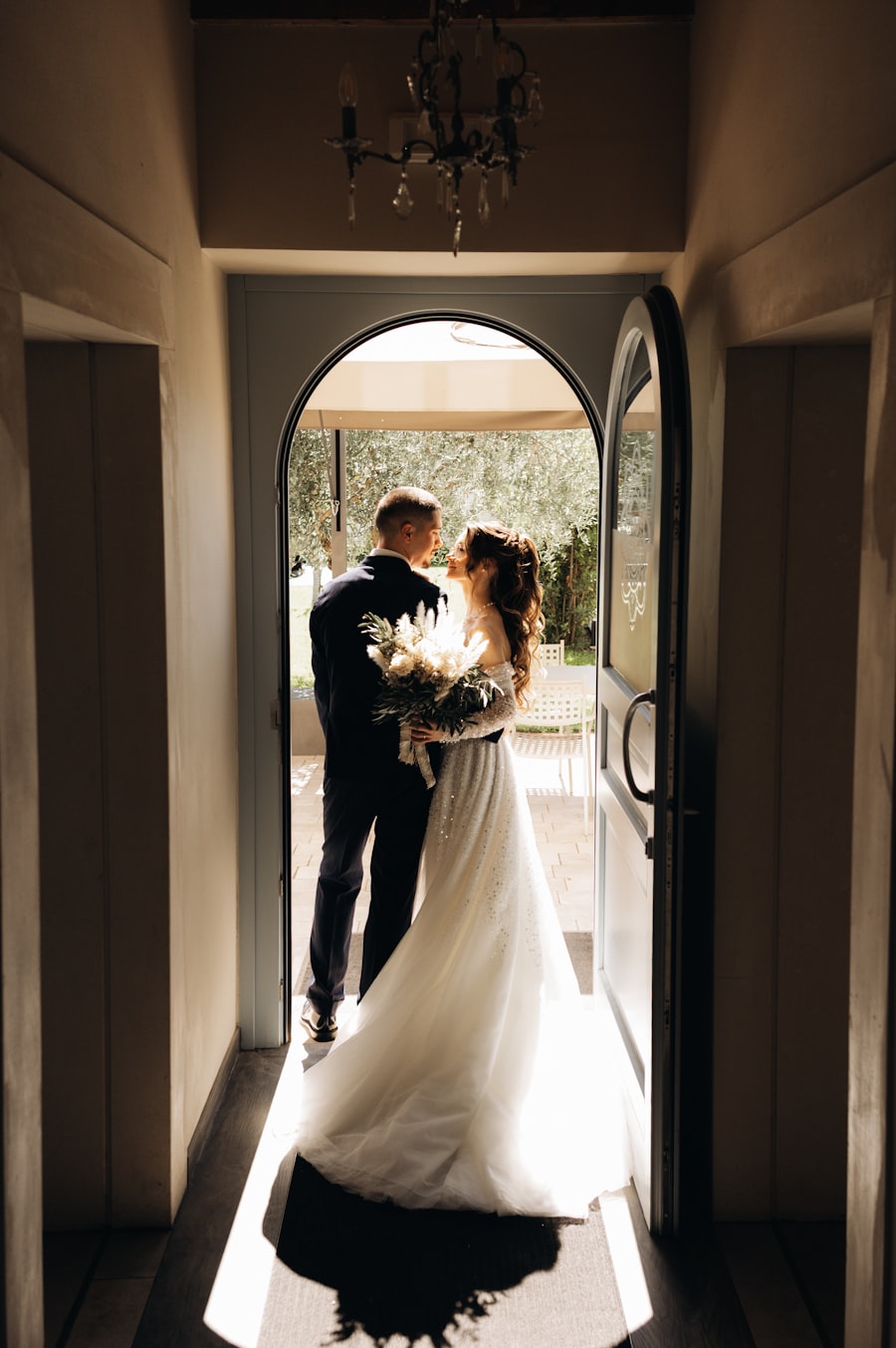 Bride and groom embracing in a doorway at sunset
