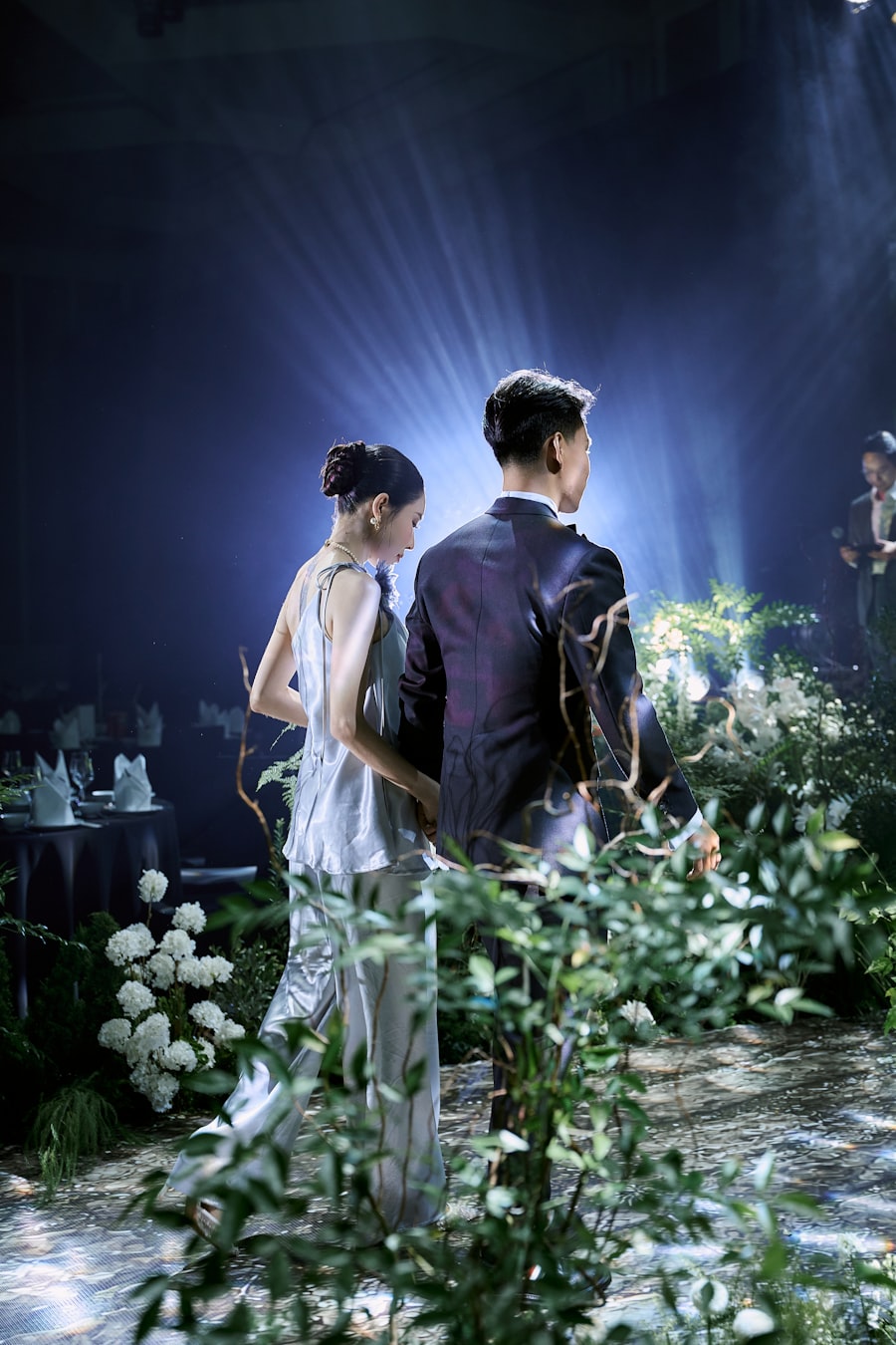 Couple walking through a dramatically lit entrance with smoke