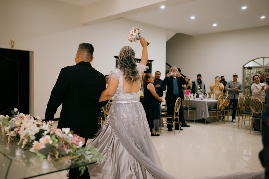 Bride raising her bouquet while entering the reception to applause