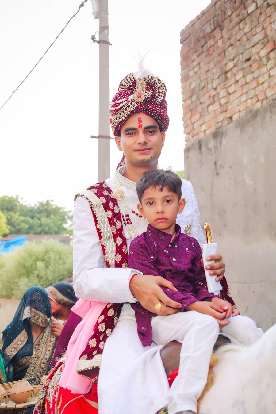 Groom in wedding turban with his nephew on the baarat horse
