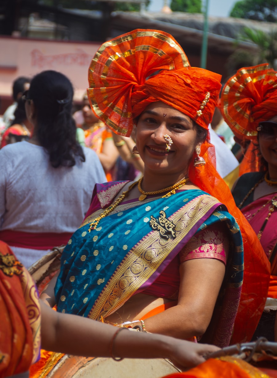 Woman playing a traditional dhol drum in festive attire