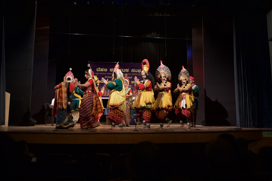 Group of dancers in traditional Yakshagana costumes on stage