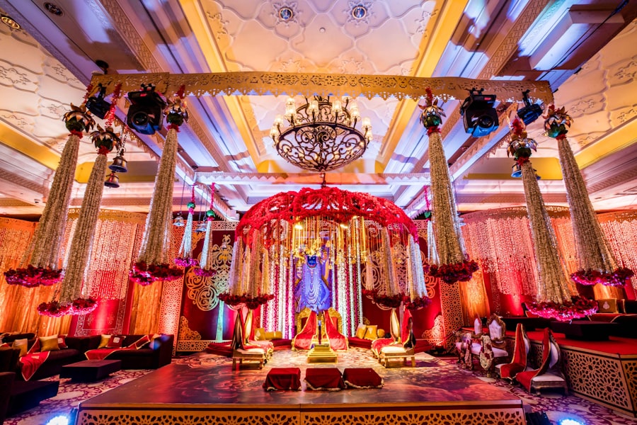 Elaborate indoor wedding stage with floral canopy and chandelier