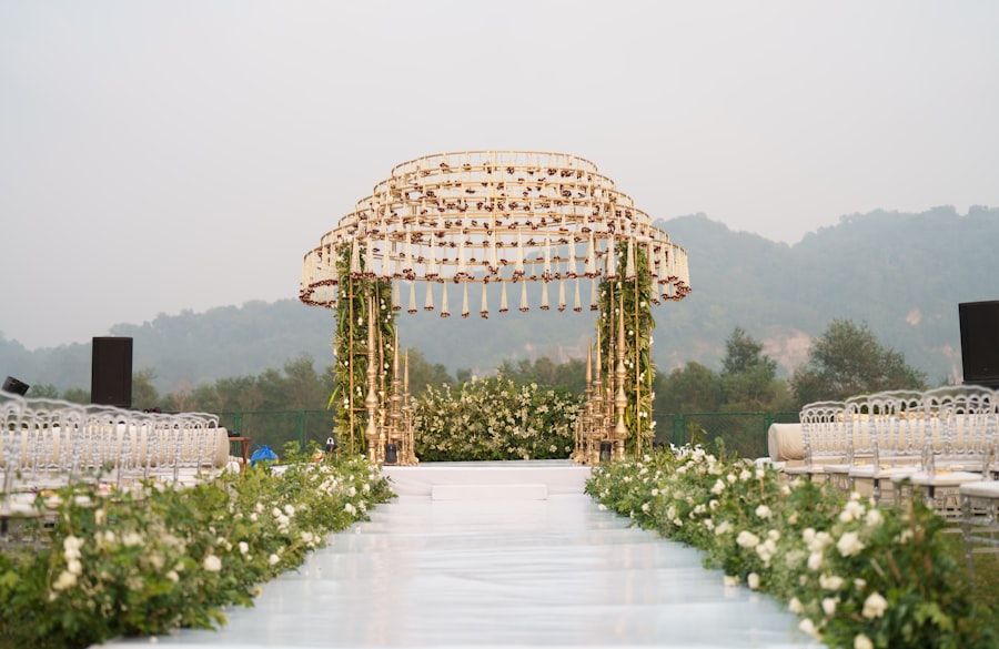 Floral wedding mandap with aisle decor against a hillside