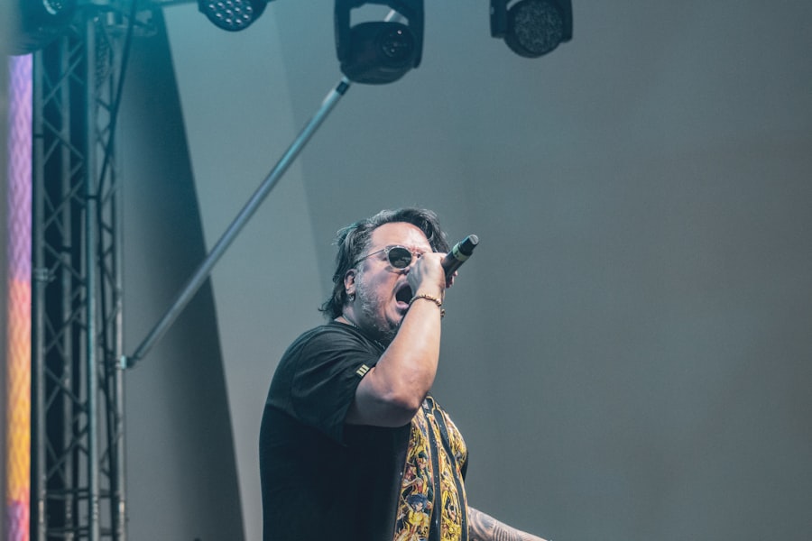 Singer performing into a microphone under stage lights