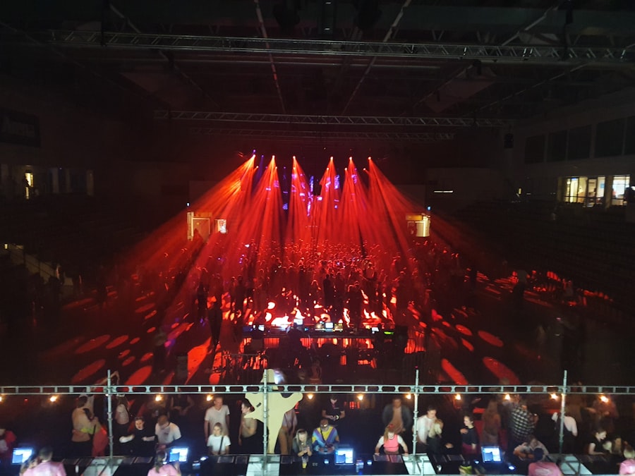 Crowd gathered around a stage lit in red at an event