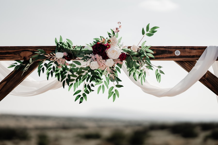 Close-up of a wooden entry arch decorated with flowers and drapery