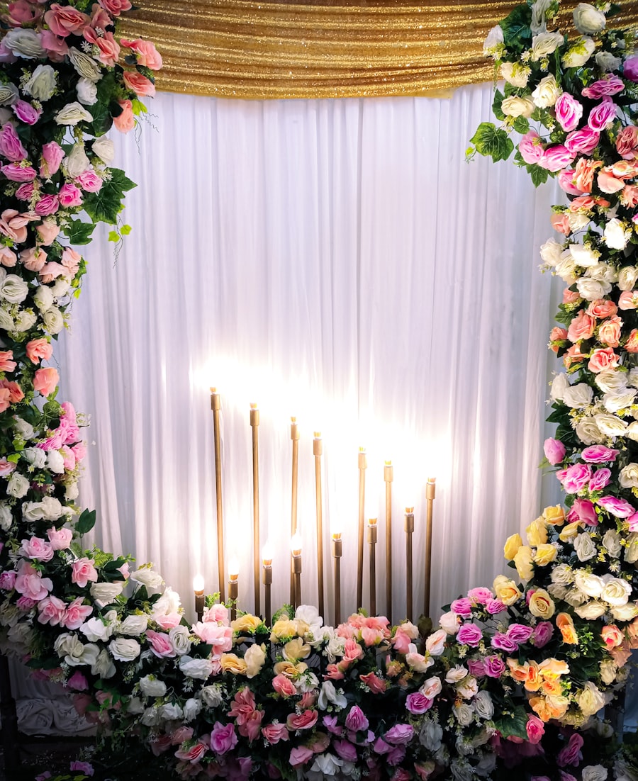 Floral wedding arch decorated with roses and candles