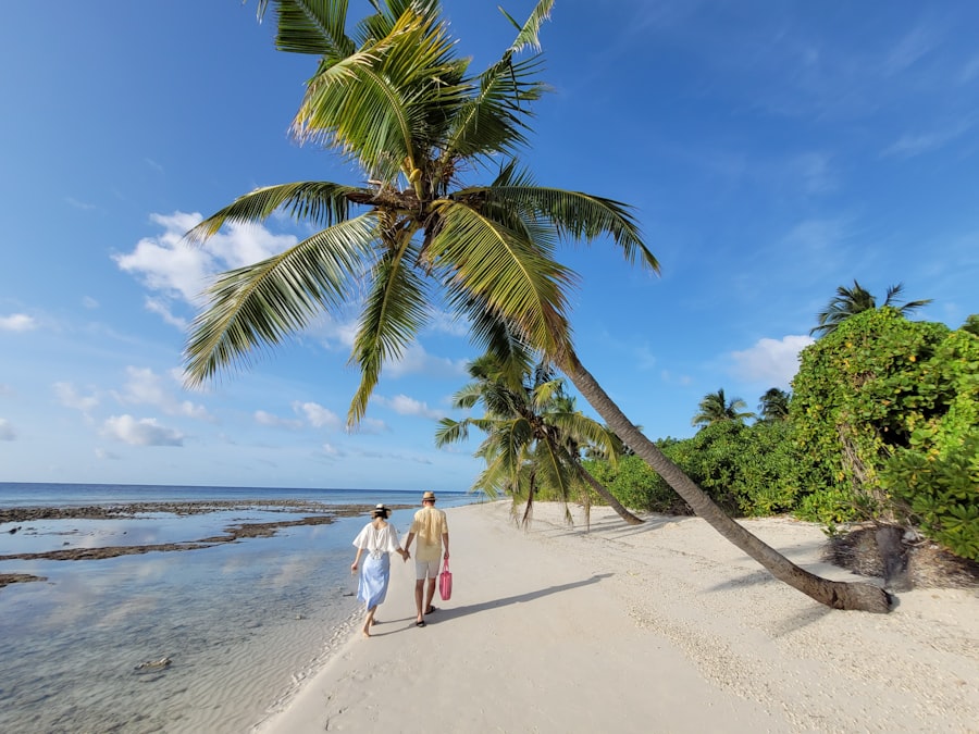Couple walking hand in hand on a tropical beach with palm trees
