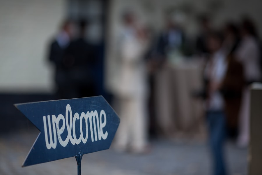 Welcome arrow sign with guests gathering in the background