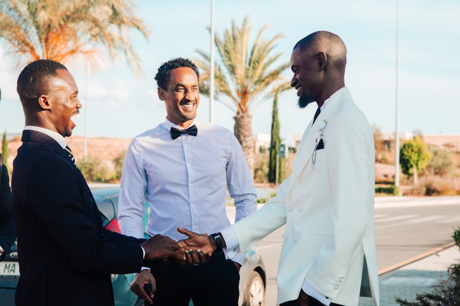 Groomsmen warmly greeting each other with a handshake