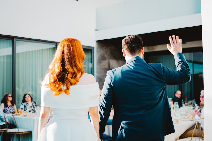 Bride and groom walking hand in hand toward waiting guests
