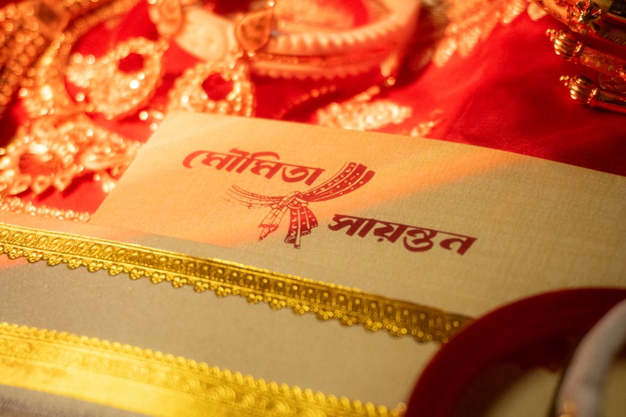 Wedding invitation card with names in gold foil beside jewelry