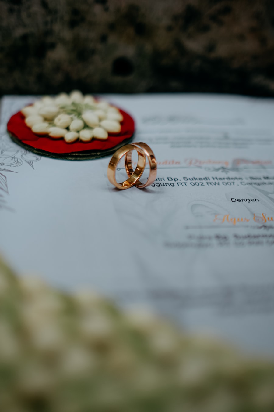 Wedding rings resting on an invitation card
