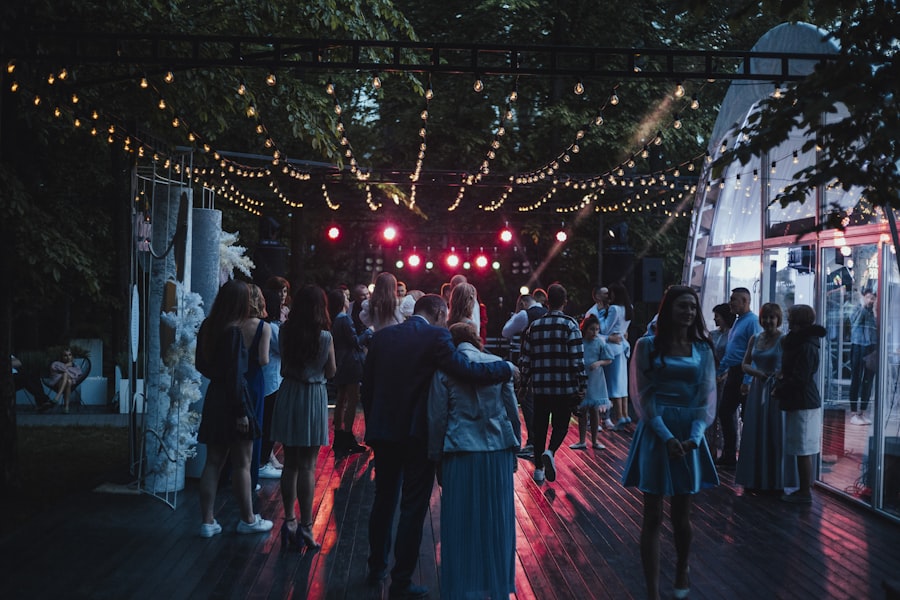 Bride and groom silhouetted under a string of fairy lights