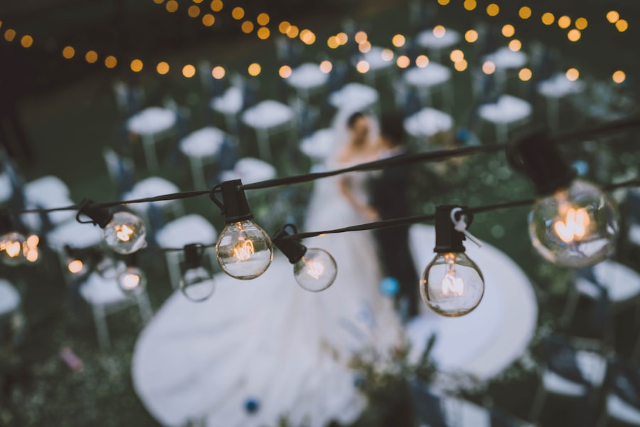 Barn wedding ceremony strung with warm fairy lights