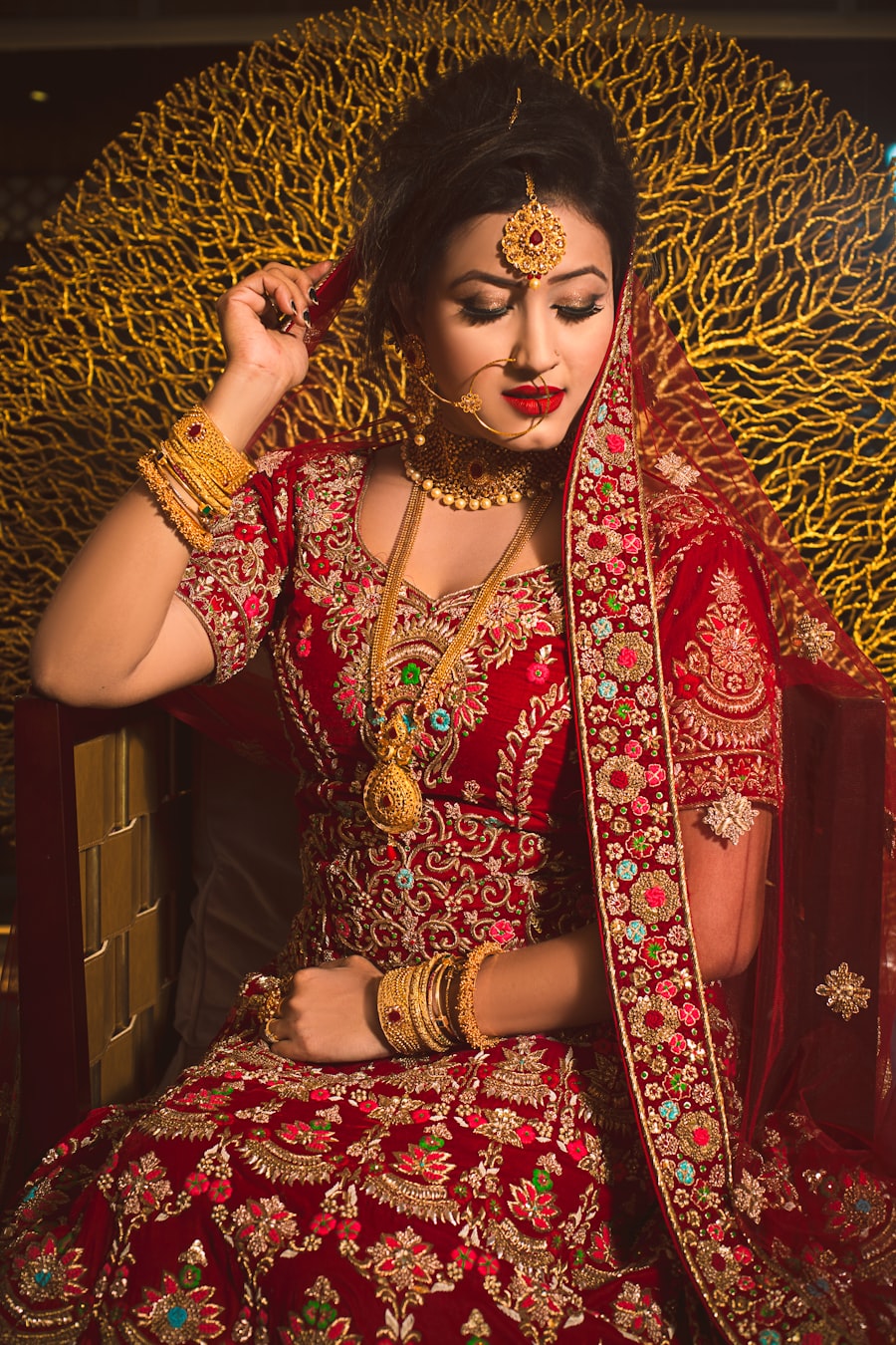 Bride in red and gold bridal makeup and attire