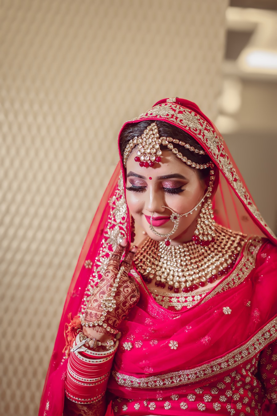 Bride with soft bridal makeup under a red veil