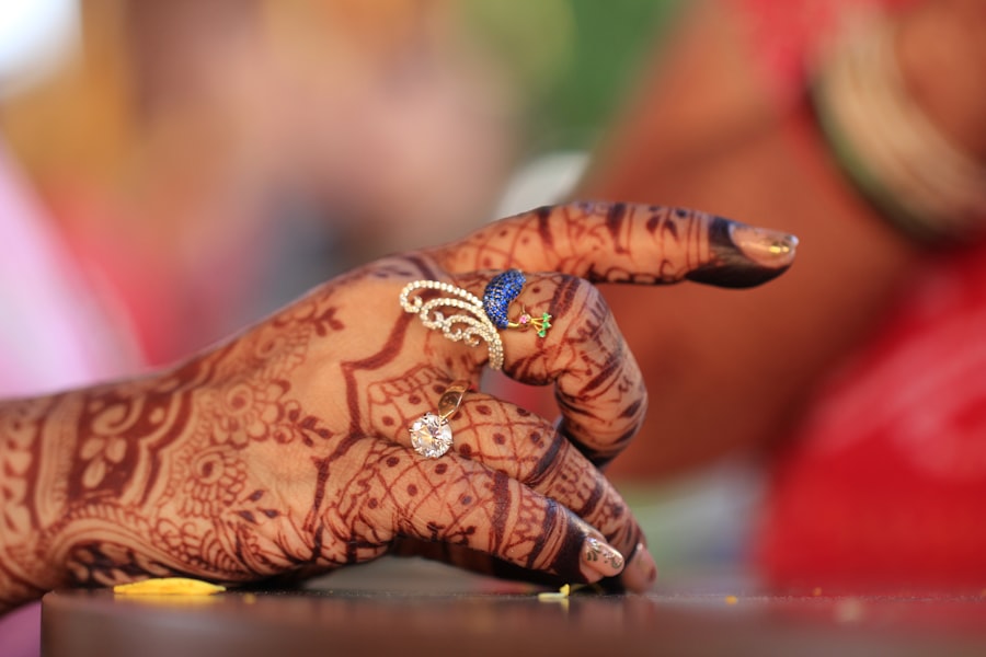 Close-up of a hennaed hand adorned with rings