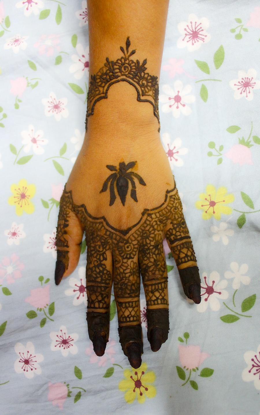 Intricate henna pattern covering the back of a hand
