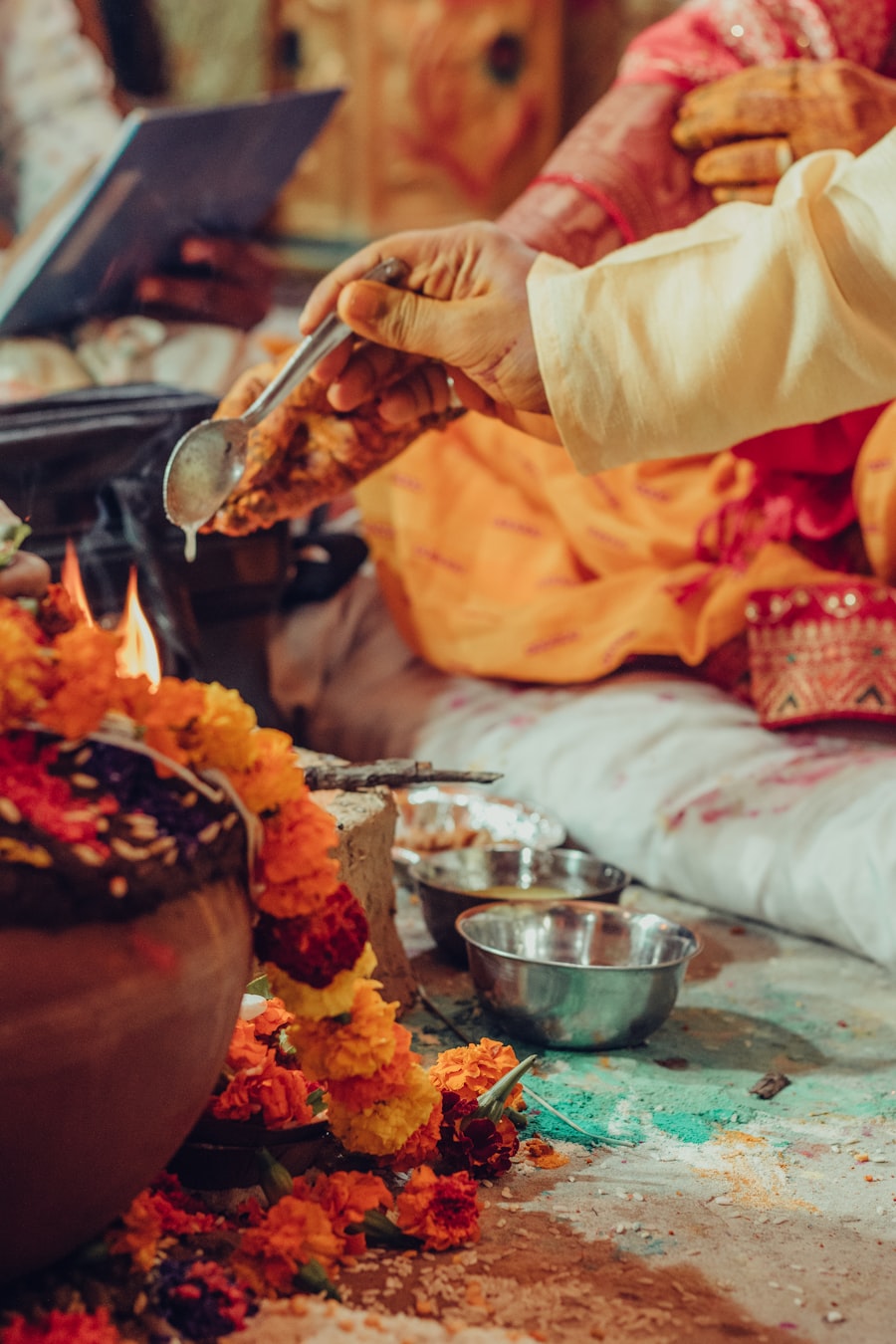Pandit performing rituals under a floral mandap
