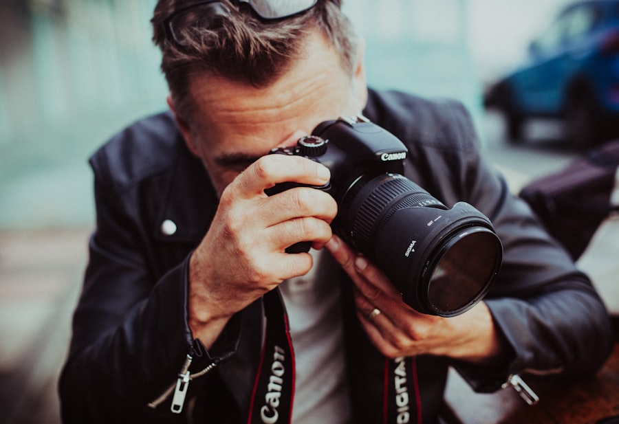 Photographer holding a DSLR camera up to shoot