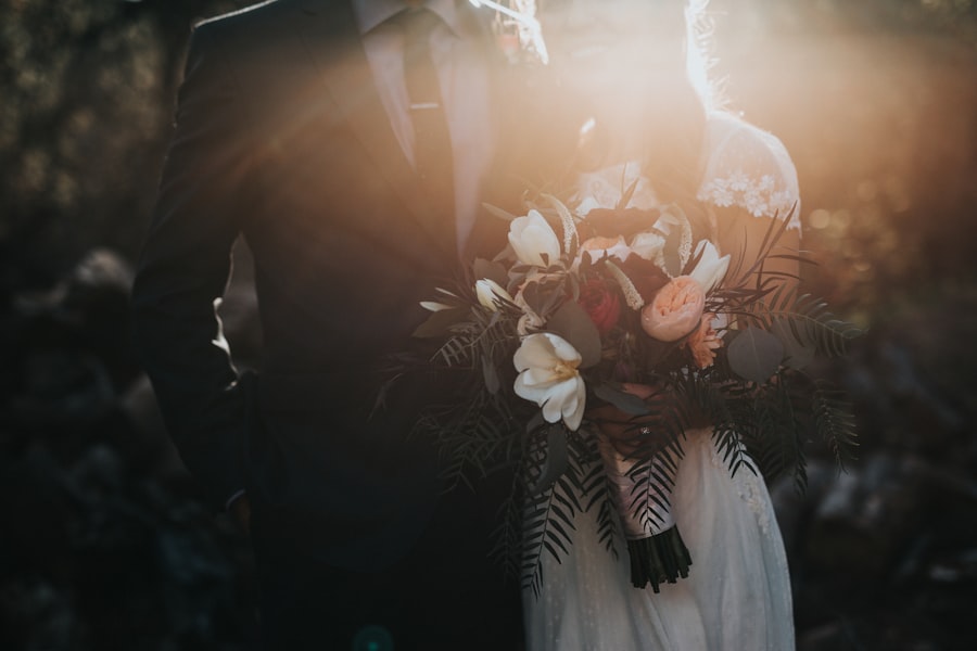 Backlit couple holding a bouquet at golden hour
