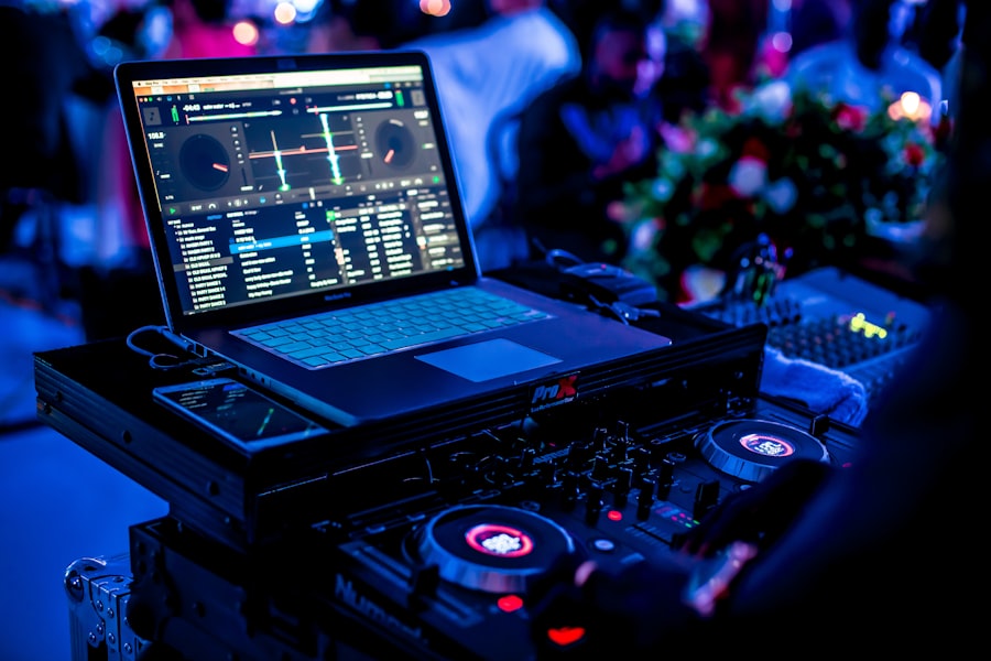 DJ mixing on laptop and controller at a wedding reception