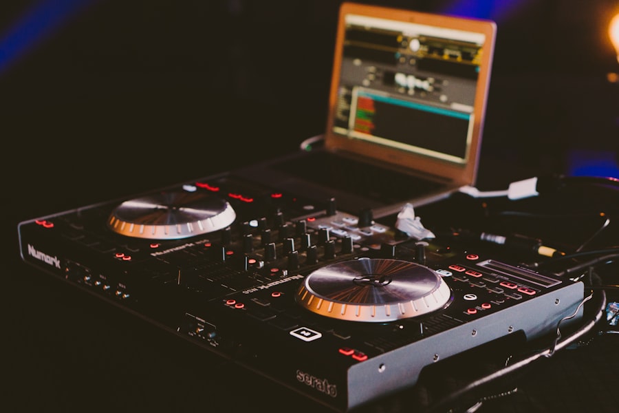 DJ controller and laptop glowing in a dark venue
