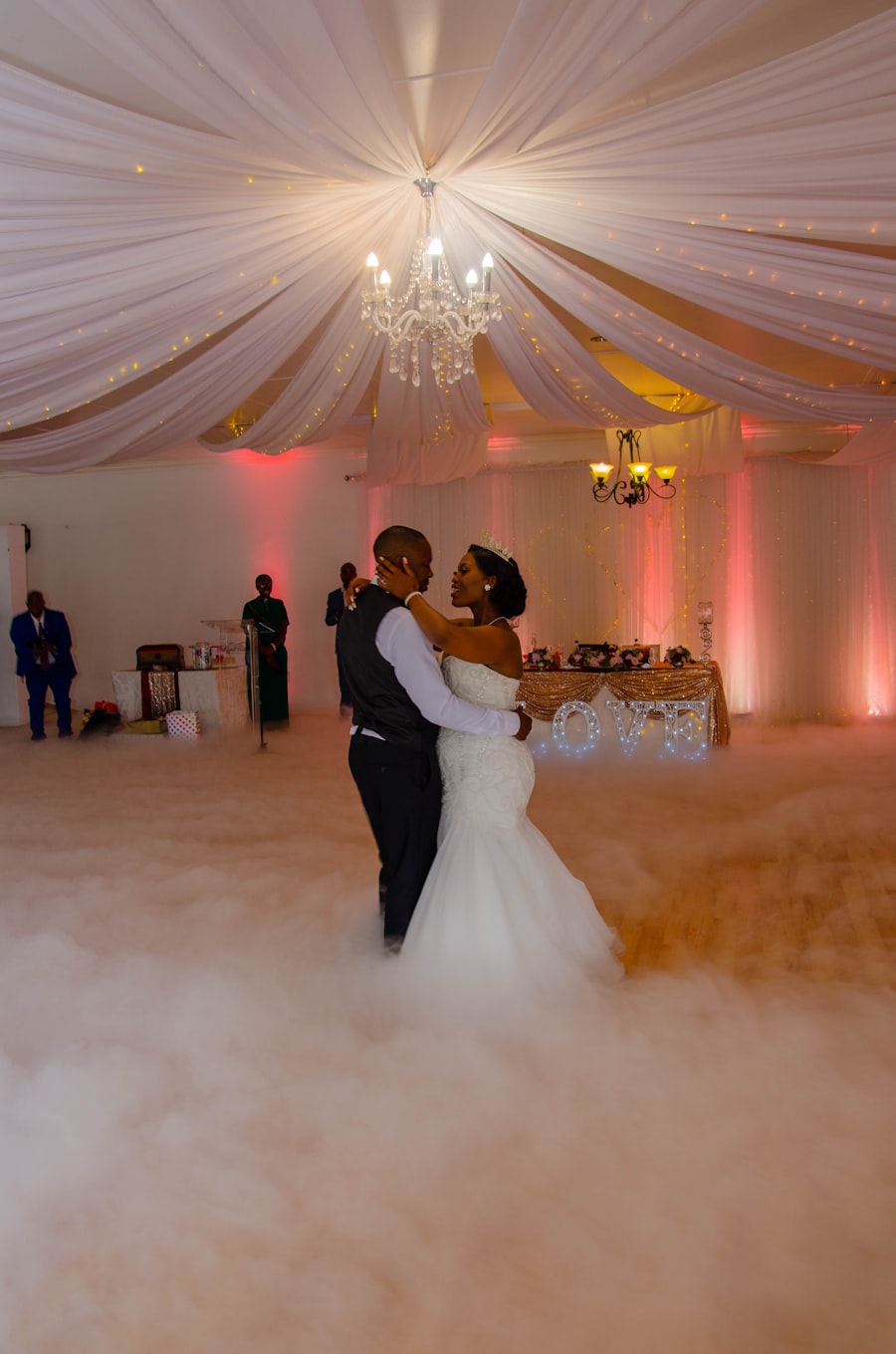 Bride and groom dancing together under stage lighting