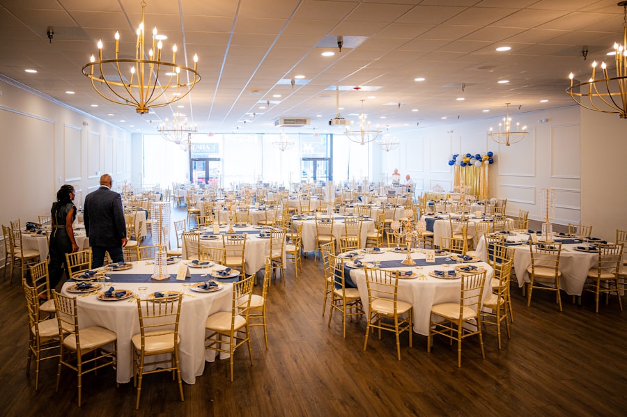 Couple walking through a chandelier-lit banquet hall